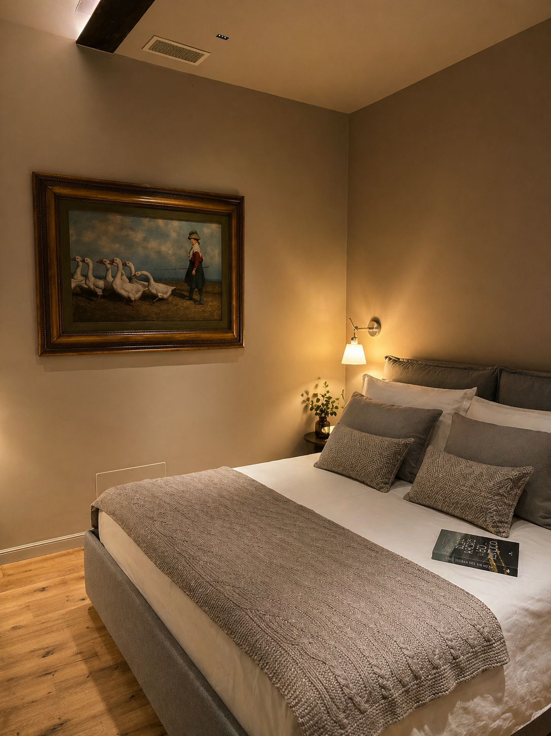 Guest bedroom with antique pastoral painting of a shepherdess and geese