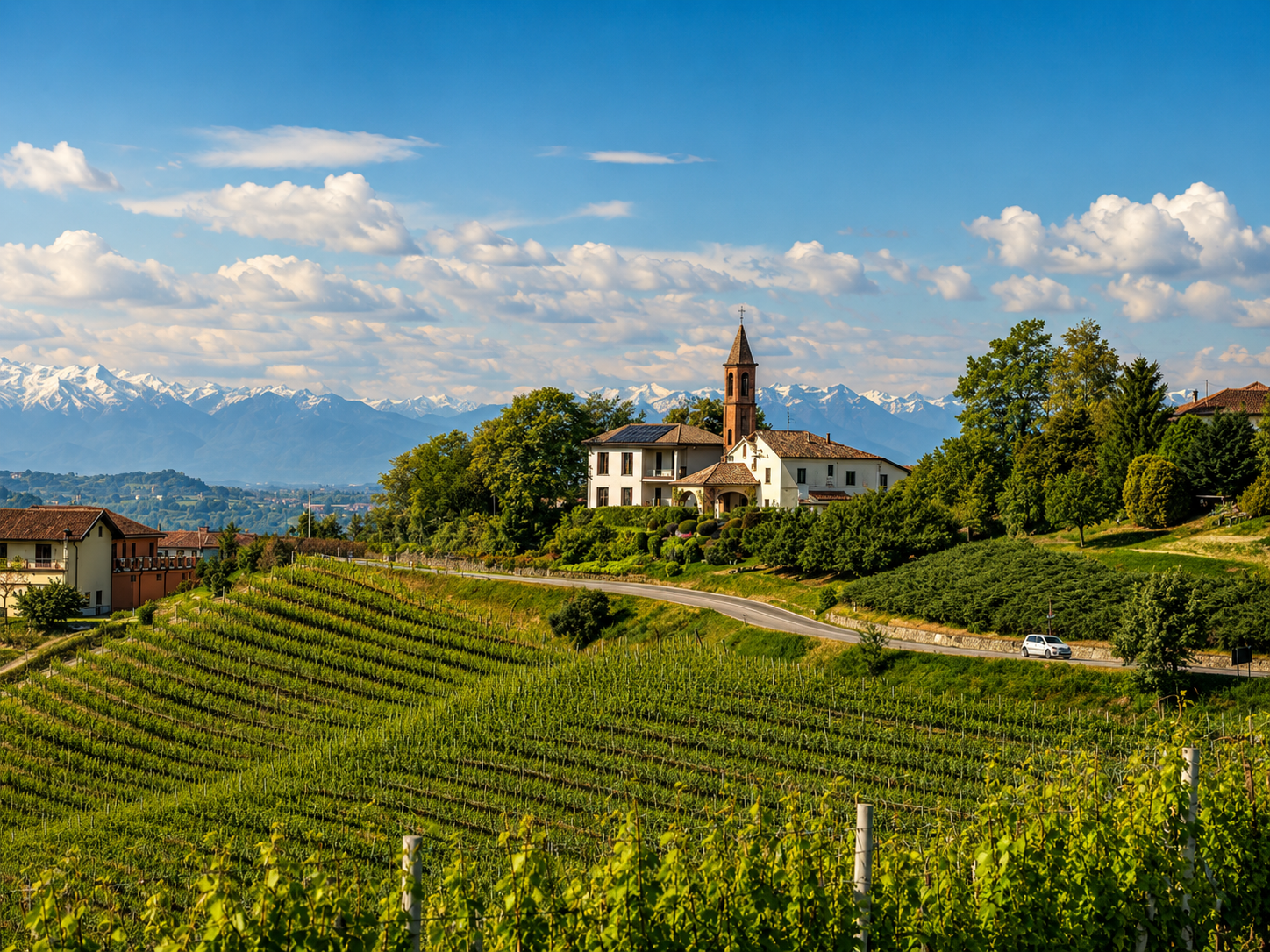 Villa Irene Langhe with bell tower overlooking Langhe vineyards and snow-capped Alps, Monforte d'Alba